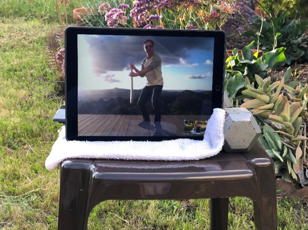 An Aikido teacher, Dave Goldberg, as seen on Zoom, teaching a solo practice with jo (a straight staff) from his deck during the Covid-19 pandemic.
